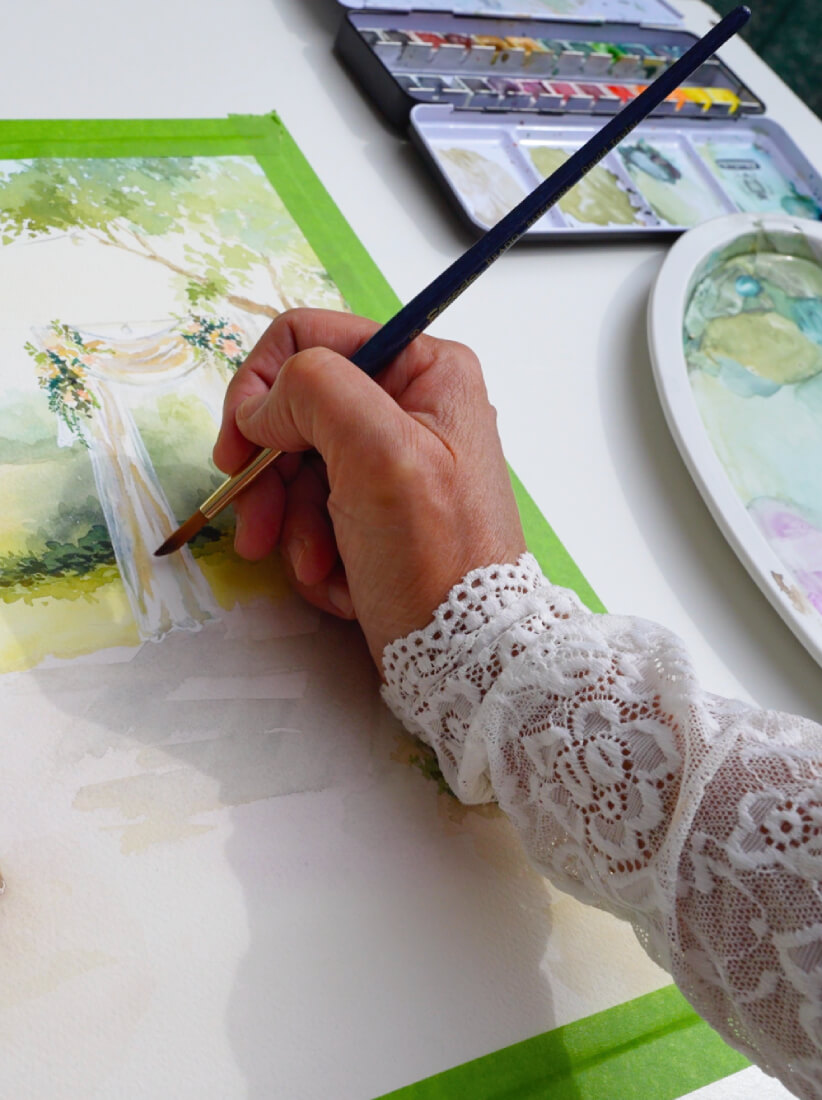 Samira, artiste live painting mariage en Belgique, peignant une aquarelle de mariage